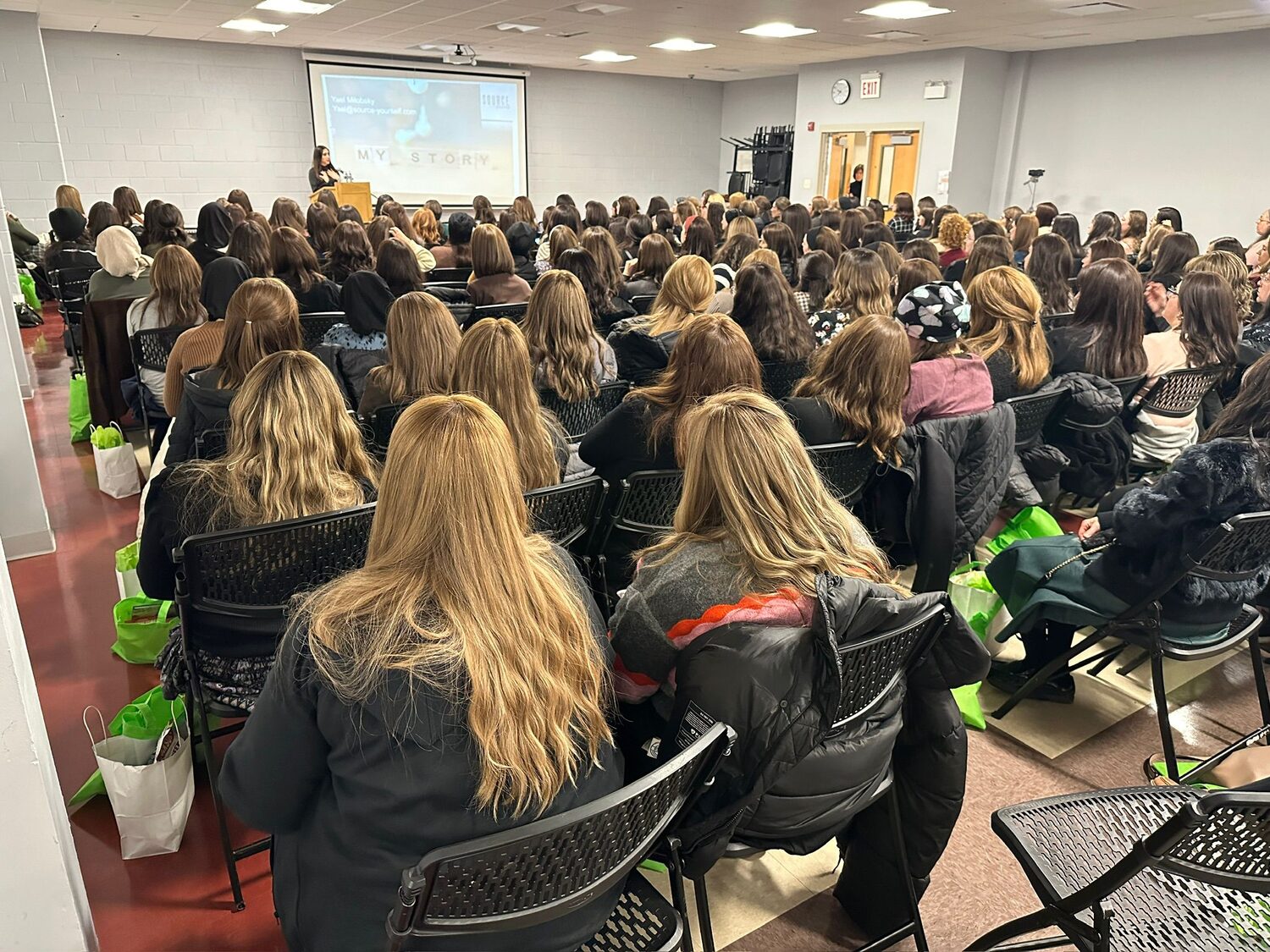 A packed Nourish to Flourish parent night with a speaker presenting