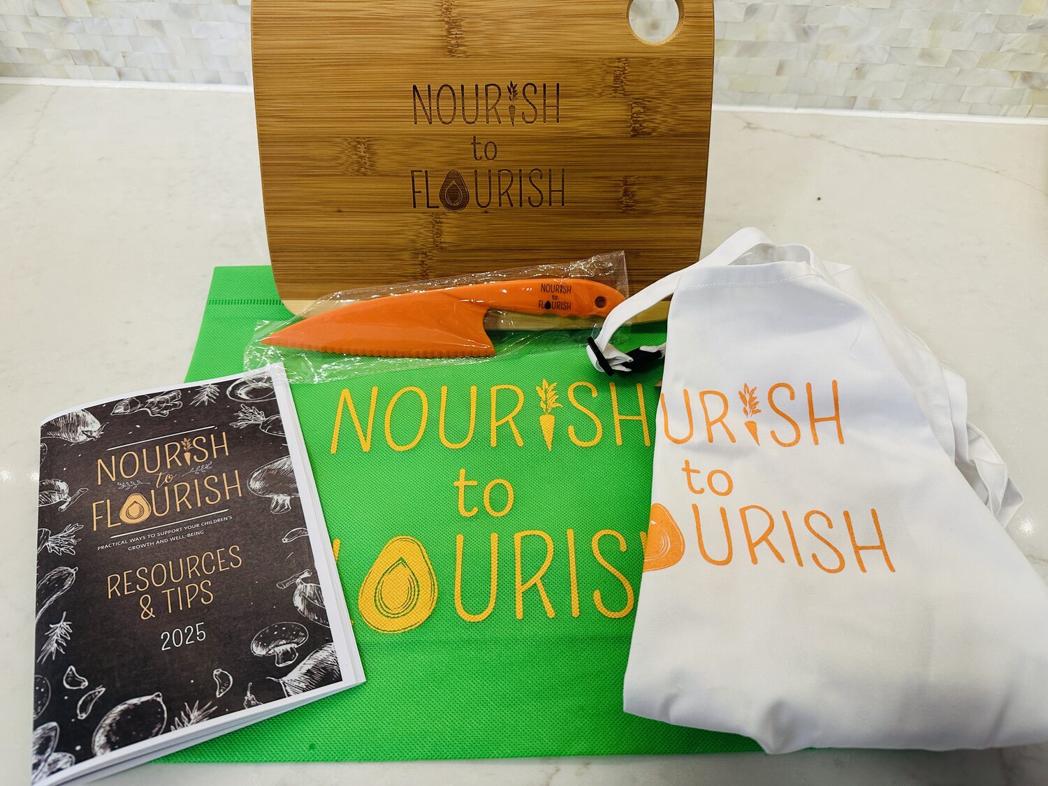 Nourish to Flourish branded cutting board, knife, tote bags and resource guide